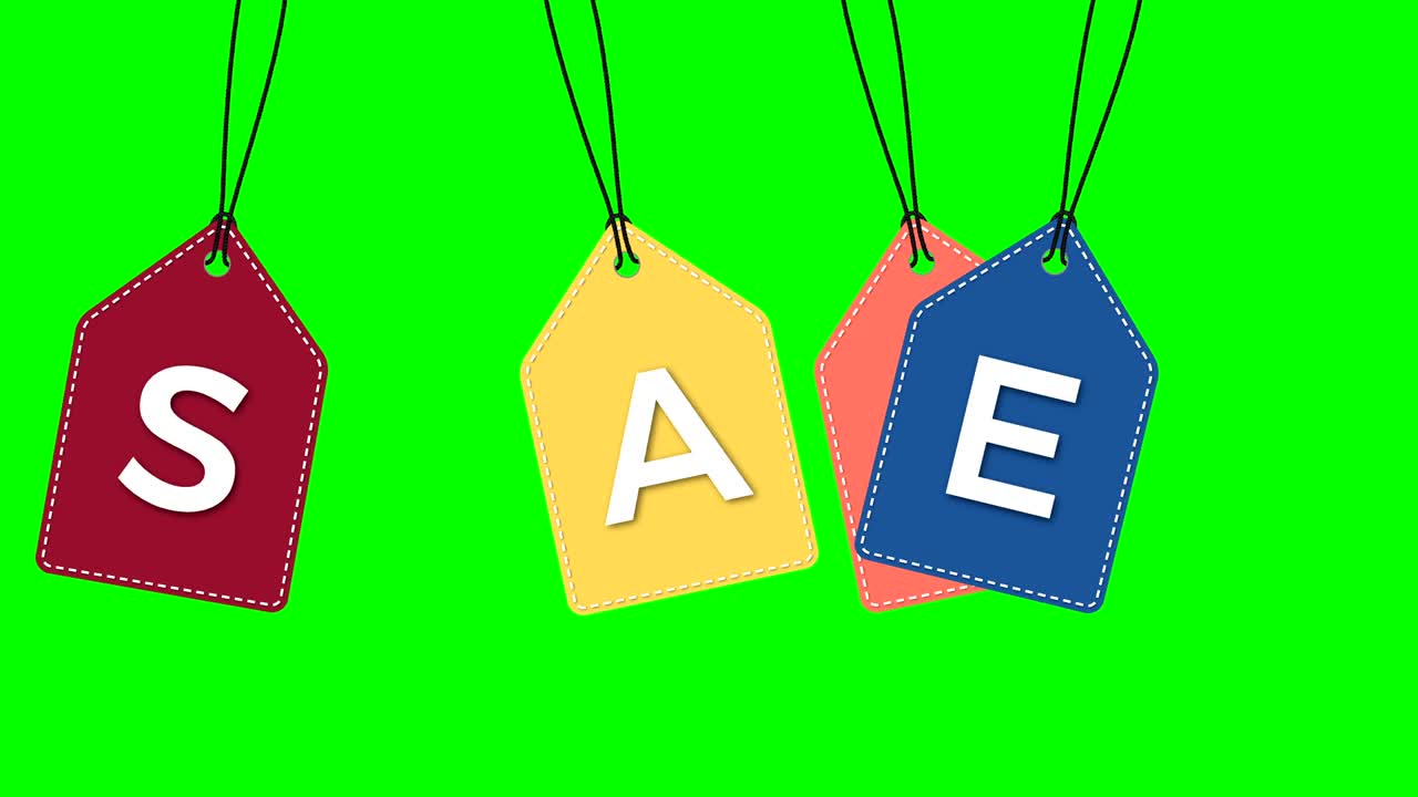 Colored hanging sale labels  isolated on green.