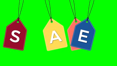 colored hanging sale labels  isolated on green.