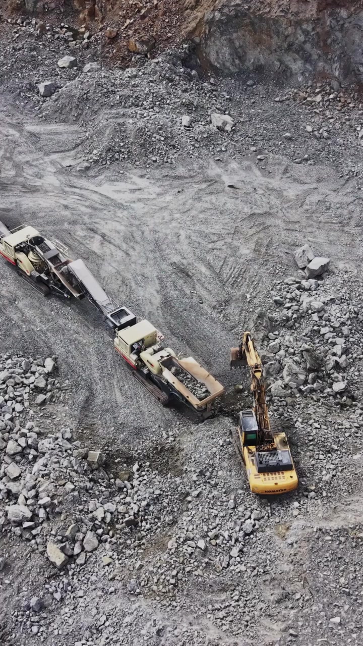 Top-down view of industrial loader and conveyor shadows