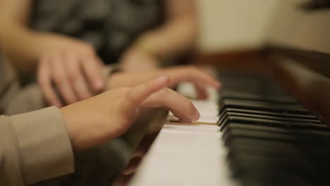 close-up of a child's hands playing the piano.