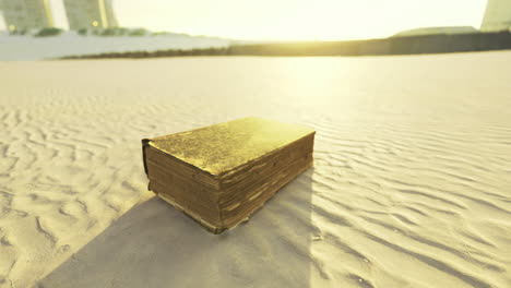 libro de oro descansando en la playa de arena al atardecer cerca de edificios altos