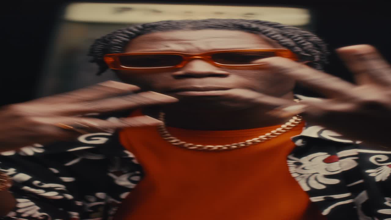 Black Hip-Hop Musician Performing Rap against Street Payphone