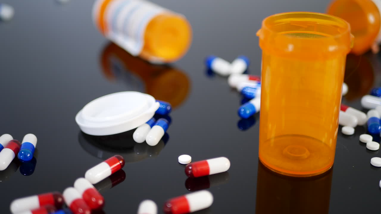 Prescription drug antibiotics with pill bottles among the medicine capsules and tablets