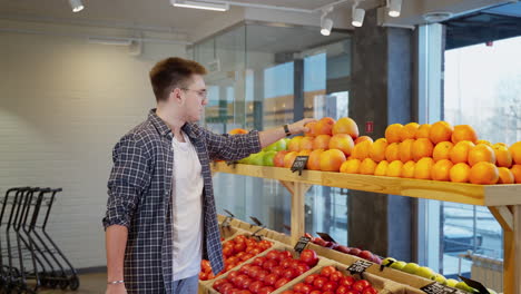 man shopping for fruits and vegetables in a grocery store