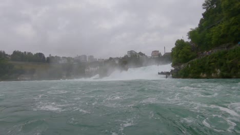 view from boat on rhine falls waterfall, rapid rough water, switzerland