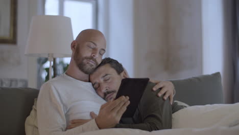 Homosexual-man-sleeping-on-his-lovers-shoulder-in-morning