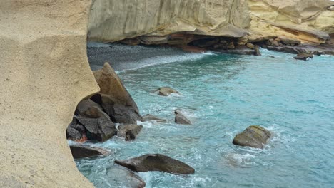 rocky volcanic shore of tenerife island with calm atlantic ocean