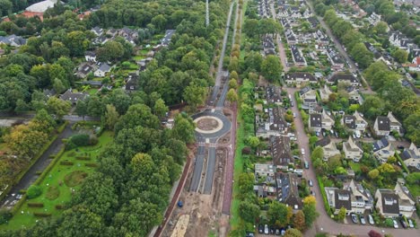 beautiful aerial of a long road under construction in a small town in rural holland