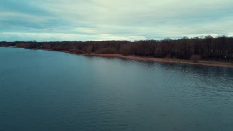 Drone-view-of-Saint-Quentin-Pond,-It's-the-largest-body-of-water-in-the-Yvelines-region