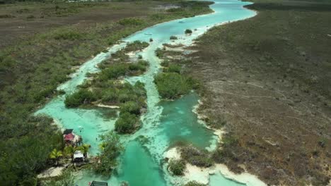 reverse drone shot of the river of los rapidos de bacalar