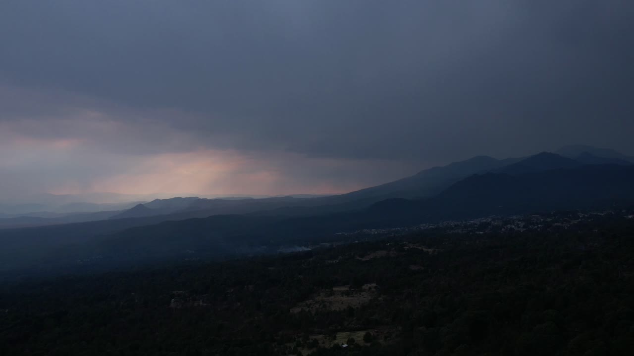 Front to back hyperlapse with view of mountains at a raining sunset