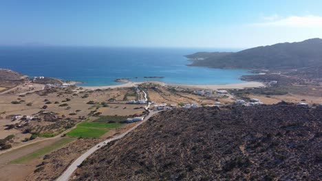 an aerial view of road to magganari beach, ios island, greece