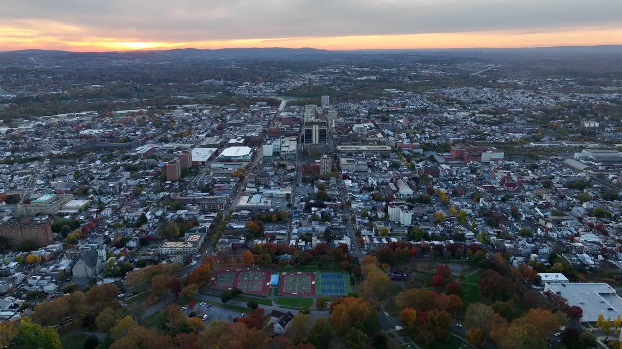 Aerial establishing shot of American city in autumn
