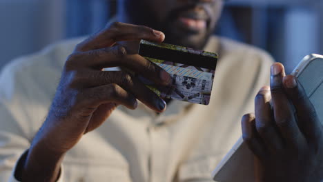 close up view of entering a credit card number while shopping something online on the tablet