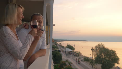 people having wine and enjoying sunset