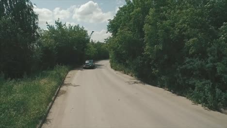 luxury car driving on a country road