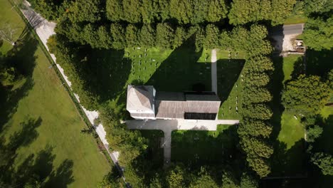 big church on a green meadow, cemetery, visby, sweden, drone