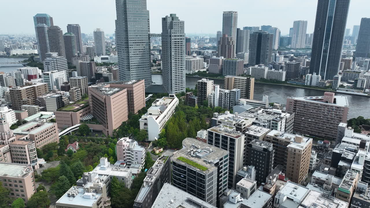 Modern Cityscape Of Tokyo, Japan On The Banks Of Sumida River In Daylight. drone shot