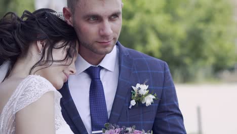 slow motion closeup bride leans on handsome smiling fiance