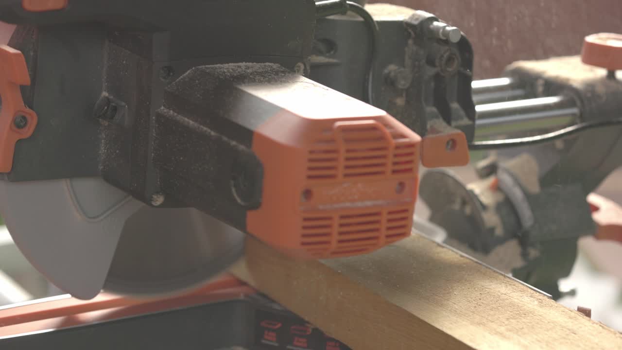 Slowmotion Close-up shot of dust particles rising from decking being cut