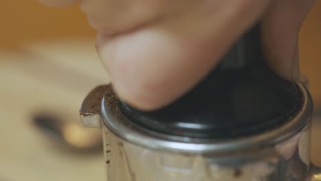 Compacting-coffee-in-an-alloy-filter-holder-in-espresso-machine-maker