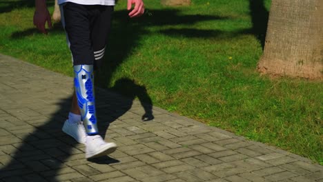 person with prosthetic leg walking outdoors