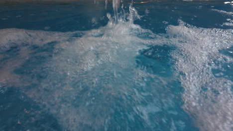 water flowing into pool with bubbles