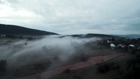 Aerial-shot-of-fog-over-houses-and-buildings