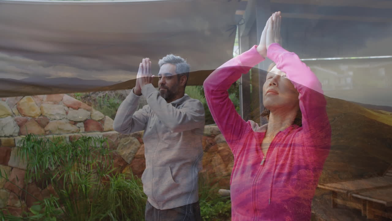 Practicing yoga outdoors, two people with serene landscape animation overlay