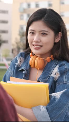 university students talking and having fun together after having classes on the college campus.