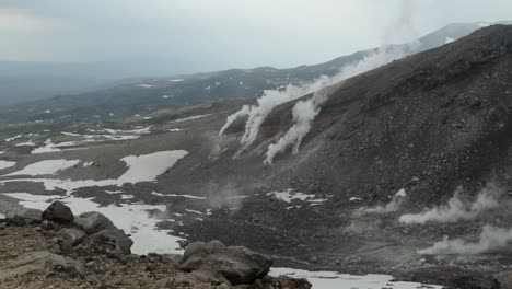 smoke emerges from slopes of active stratovolcano asahi-dake in japan, static