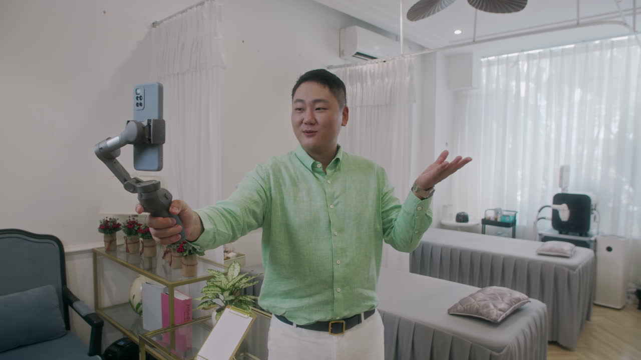 Sales Manager Going Live Holding Phone on Tripod in Spa Salon