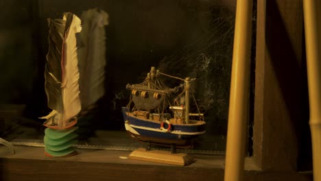 a model boat sits on cabin windowsill interior