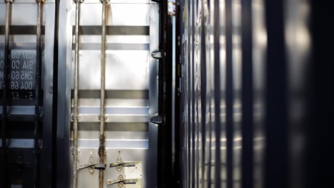 A Serene Encounter with Container Structures: Shadows and Reflections Play Across the Metallic Surfaces, Showcasing the Quiet Beauty of Industrial Design