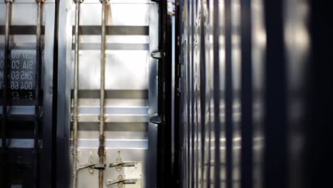 a serene encounter with container structures: shadows and reflections play across the metallic surfaces, showcasing the quiet beauty of industrial design