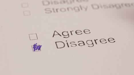 person marking disagree with a pen on a poll question