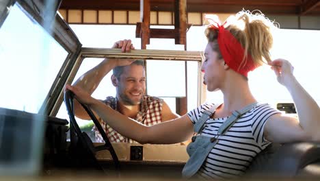 couple interacting with each other near a car 4k