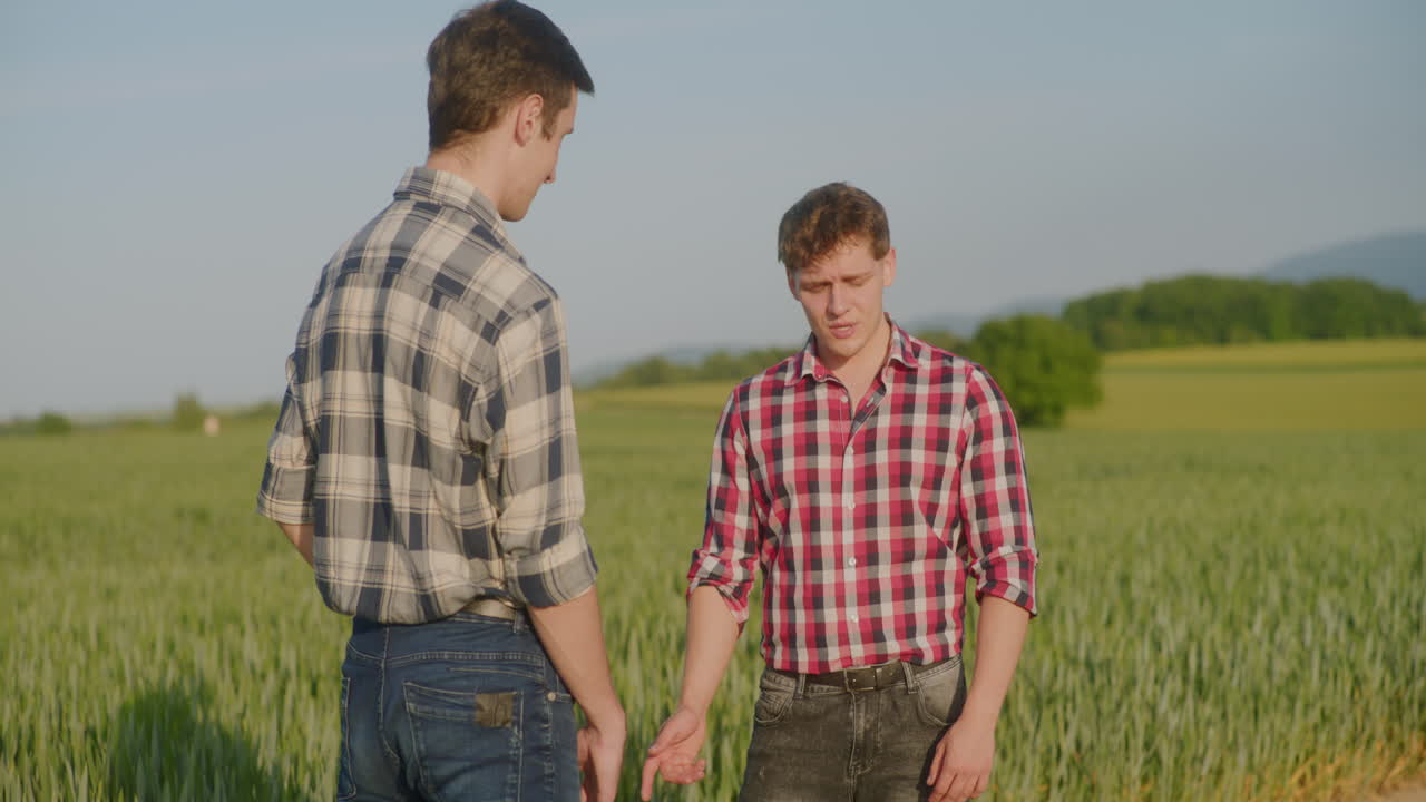 Sad Farmer Complains About Poor Crops to Fellow Farmer