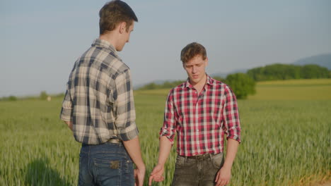 sad farmer complains about poor crops to fellow farmer