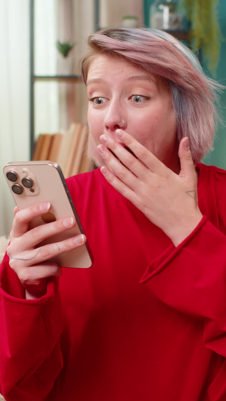 Woman surprised by unexpected money transfer on smartphone shocked happy facial expression reaction