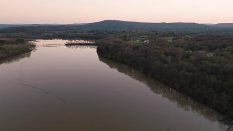 Aerial-rotating-shot-of-murky-water-within-Lake-Sequoyah-during-sunset