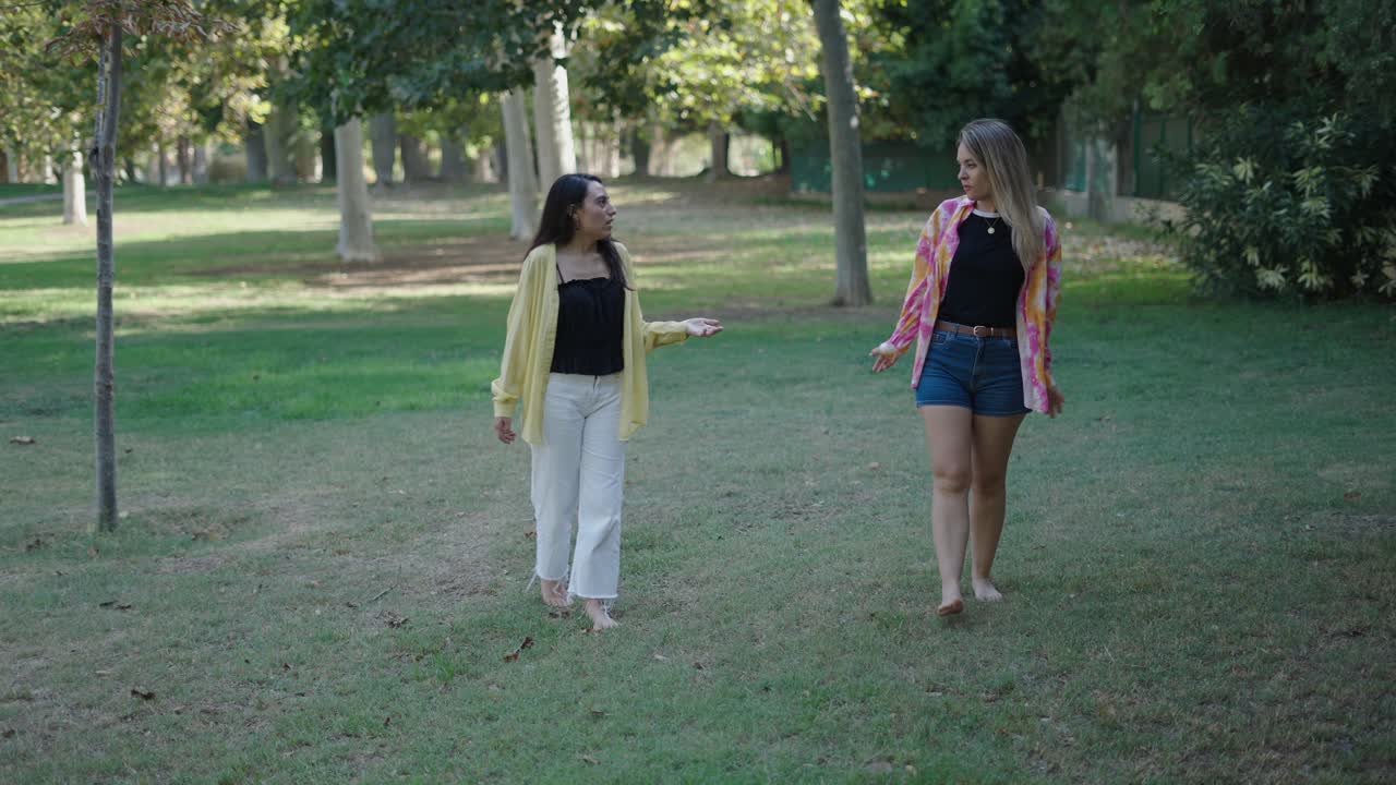 Two women walking and talking in a park