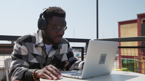 man working on laptop outdoors