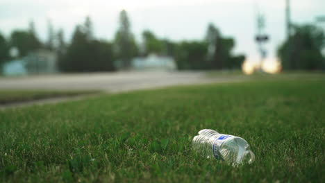 Discarded-Plastic-Bottle-on-Grass-Field:-A-Symbol-of-Environmental-Pollution