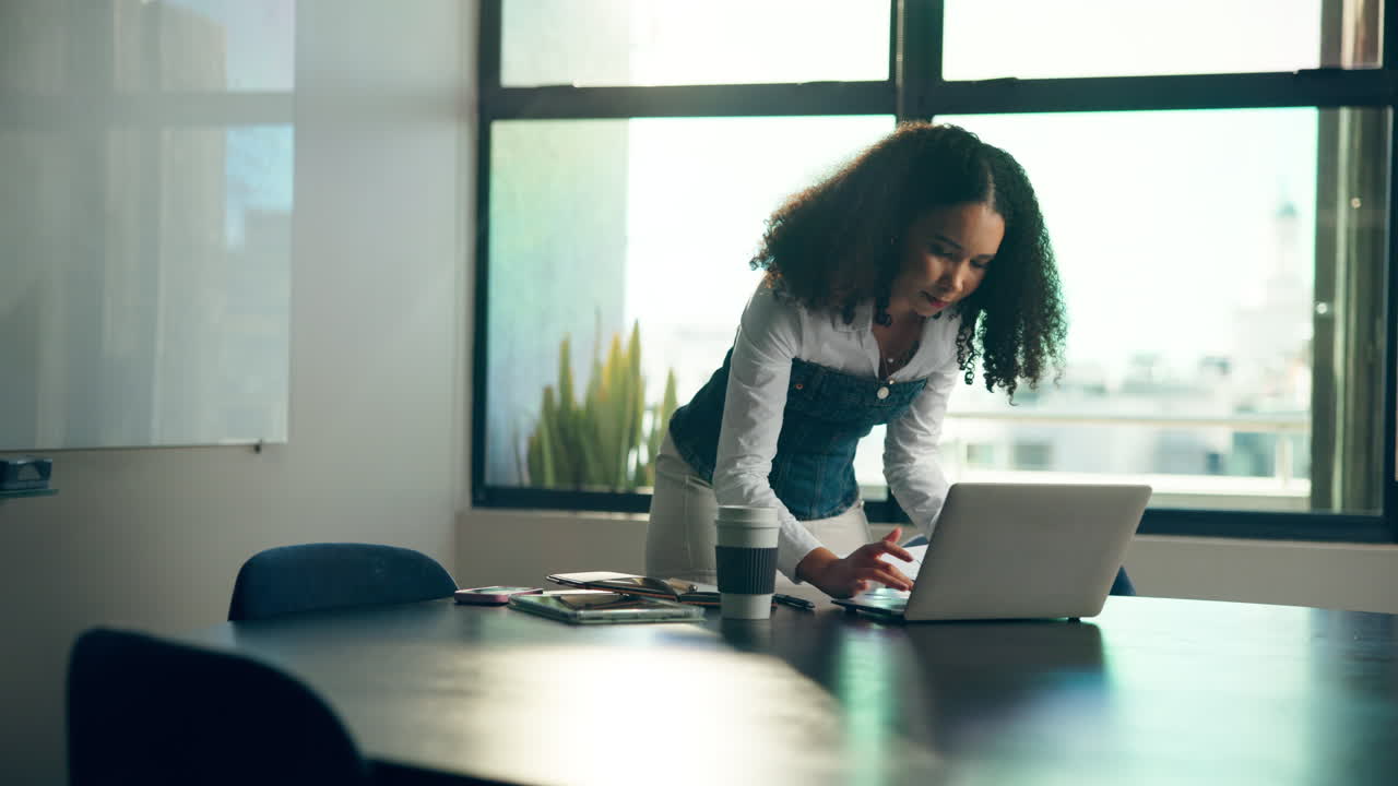 Woman working on laptop in modern office