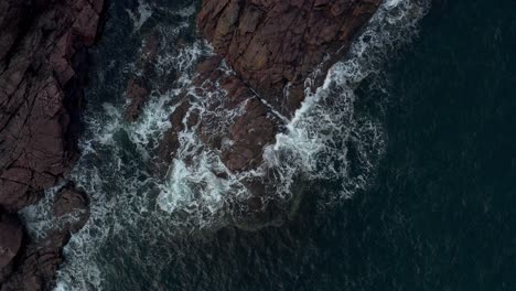 sea waves crashing against rocky cliff