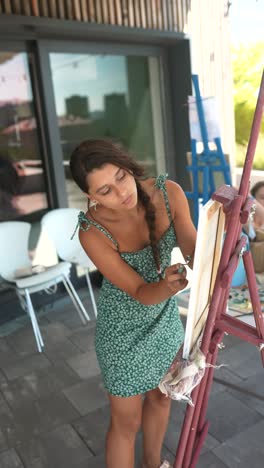 young woman painting outdoors