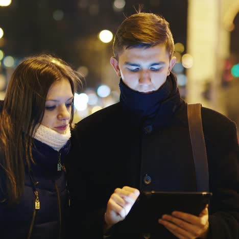 a young couple uses a tablet for directions