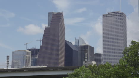 a few tall buildings in downtown houston, texas on a sunny day