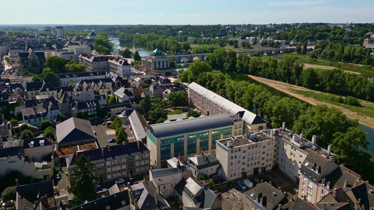 Tours cityscape, municipal library and Pont Wilson bridge over Loire River, France. Aerial drone forward view